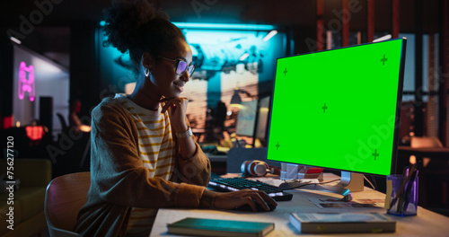Portrait of Black Female Working in Creative Agency, Implementing Modern Business Strategy for Clients. Successful Specialist Using Desktop Computer with Green Screen Mock Up Display