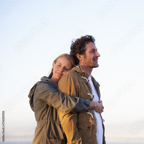 Couple, hug outdoor and peace in park, love and support with date for bonding and time together. Sunset, nature and people with calm and fresh air, loyalty and commitment with smile for affection #756285958