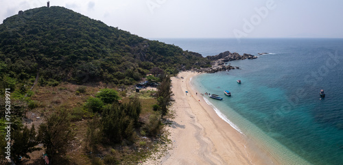Aerial drone view of spectacular white sand beach of tropical Hon Nua Island off the Central Vietnam coast, surrounded by the pristine turquoise water of the South China Sea