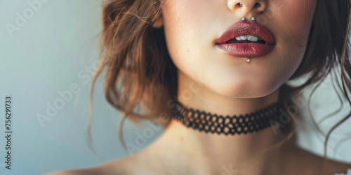 Elegant Beauty Young Woman with Choker.  Close-up of a girl with black choker on her neck, grey background with copy space.