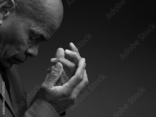 black man praying to god with hands together Caribbean man praying on black background with people stock photos stock photo 