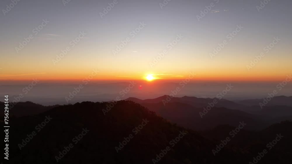 Drone flying over forest-covered mountains at sunrise, beautiful clouds Drone flying over forest-covered mountains at sunrise, beautiful clouds