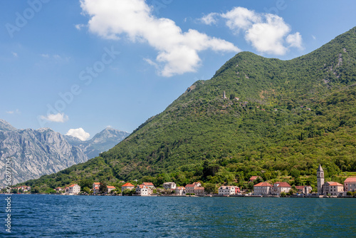 The village of Donji Stoliv on the coast of Boka Kotorska  the Bay of Kotor   Montenegro  with the abandoned village of Gornji Stoliv high above