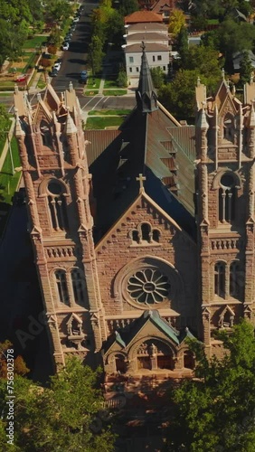 Flying around the gorgeous historic landmark in salt Lake City, Utah, USA. Gothic building of Cathedral of Madeleine from aerial perspective. Vertical video. photo