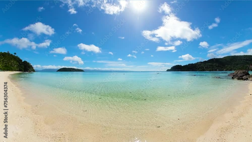 Sun reflection over transparent sea water and sandy beach in Tiamban Beach. Romblon Island. Philippines. Sun reflection over transparent sea water and sandy beach in Tiamban Beach. Romblon Island. Philippines.