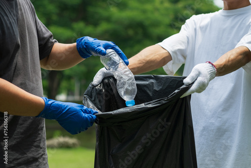 Volunteers collect garbage. The concept of plastic waste Clean up the earth. Pick up trash. Protect the environment. Campaign about plastic waste.