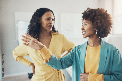 Smiling african american businesswomen talking together in an office boardroom