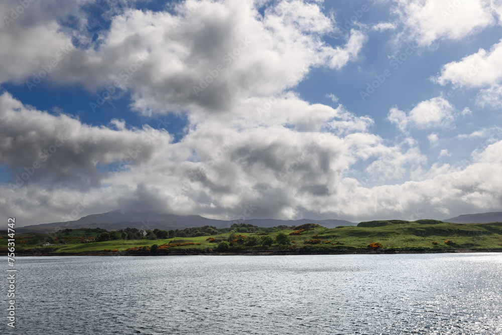 A serene seascape captures the tranquility of the waters near Skye, with gentle hills and a dynamic skyscape completing the scene A serene seascape captures the tranquility of the waters near Skye, with gentle hills and a dynamic skyscape completing the scene