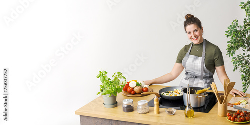 Woman cooking pasta with fresh vegetables