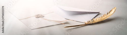 Golden pen and stamped envelope