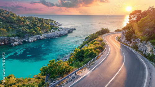 Scenic coastal road winding along turquoise water at sunset