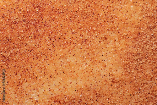 Granulated sugar and ground cinnamon close-up on the surface of the dough, macro photo