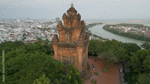Aerial drone shot of the stunning historical Nhan Temple, an architectural cultural heritage of the Cham people, elevated on a green hillside above the city of Tuy Hoa, Vietnam photo