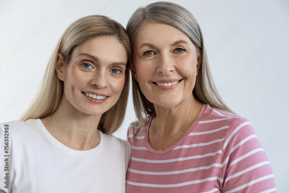 Two smiling pretty ladies looking happy and contented Two smiling pretty ladies looking happy and contented