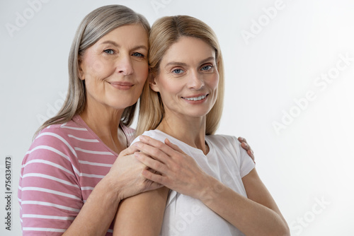 Mom hugging her daughter and smiling happily