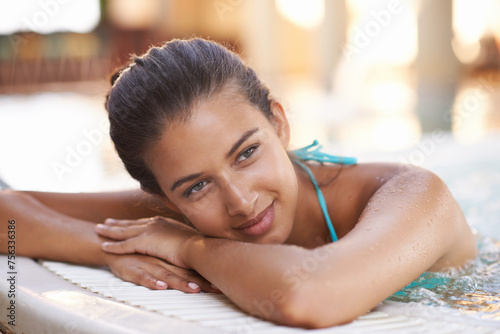 Woman, thinking and smile in jacuzzi at spa for luxury vacation, summer holiday and resort on weekend. Tourist, girl and face with happiness in pool for daydreaming, fun getaway or wellness in bikini