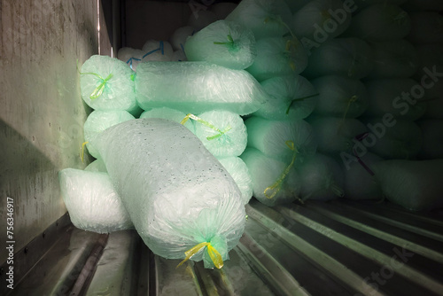 The close-up shows stacks of ice bags neatly arranged inside a delivery truck, ready to be transported to their destination.