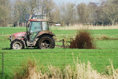 Tractor with trencher in a field