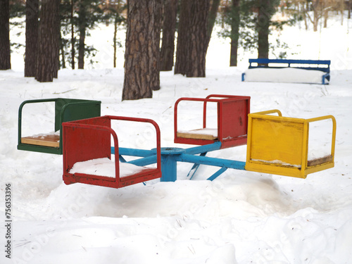 Colorful children's playground in the park on a sunny winter day