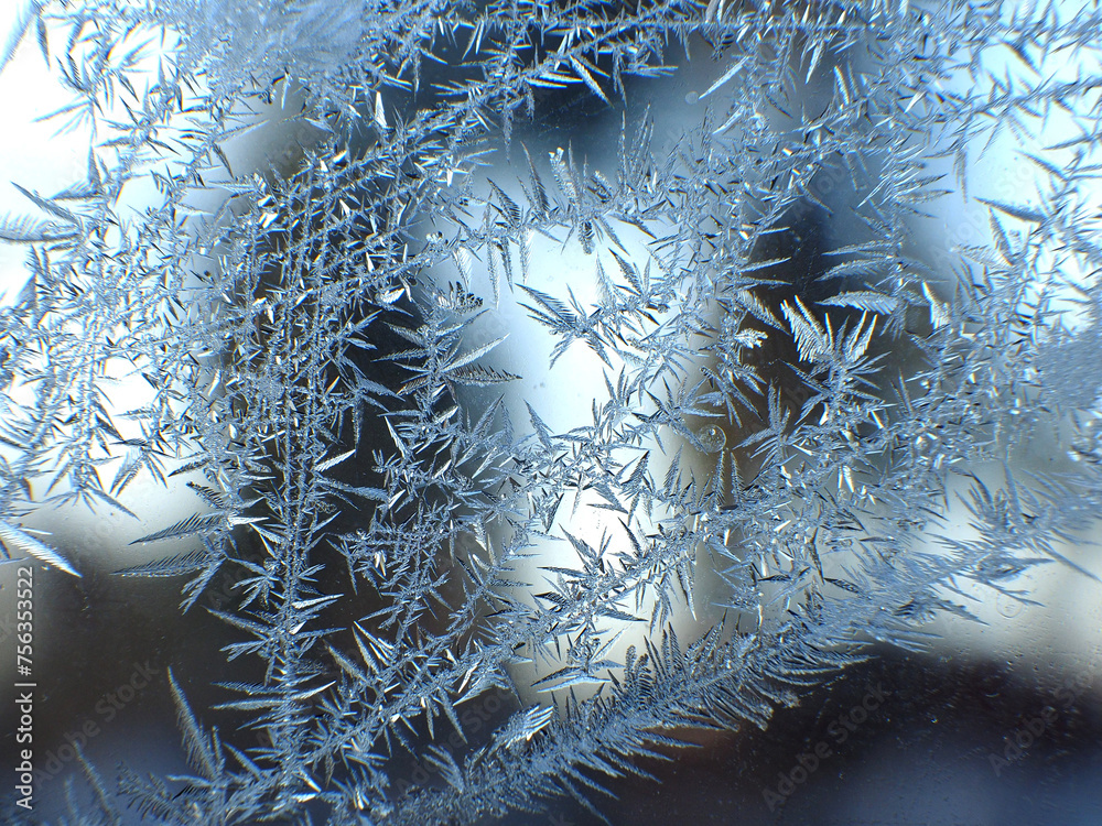 Frosty natural pattern on winter window glass. Abstract background.
