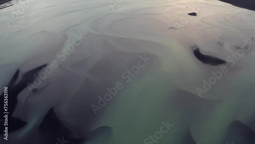 Colorful Braided Flows Of Olfusa River In Iceland. aerial tilt-up shot photo