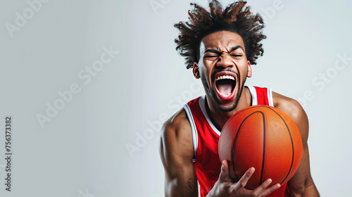 A man with dreadlocks is holding a basketball and yelling