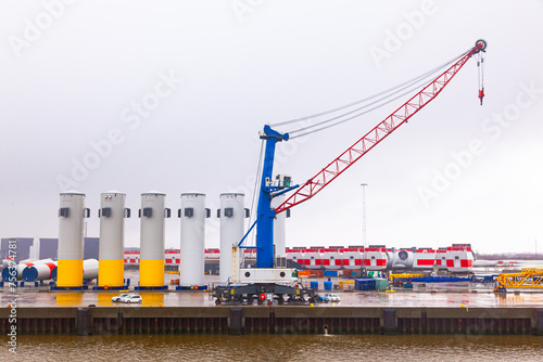 Onshore storage of blades and parts for wind generators at a seaport in Germany.