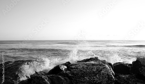 Waves breaking on rocks on the cliffs and foaming, sea and ocean views, wild seas, black and white
