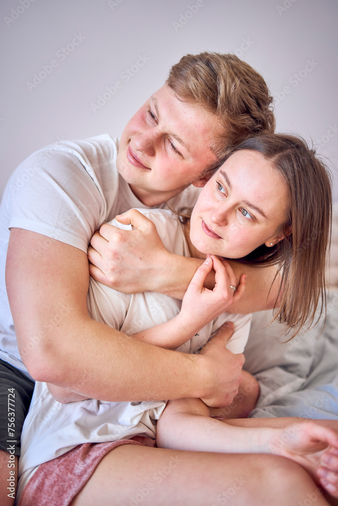 a man hugs his wife from behind, face to face a man hugs his wife from behind, face to face