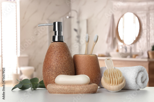 Bath accessories. Different personal care products and eucalyptus leaves on white table in bathroom