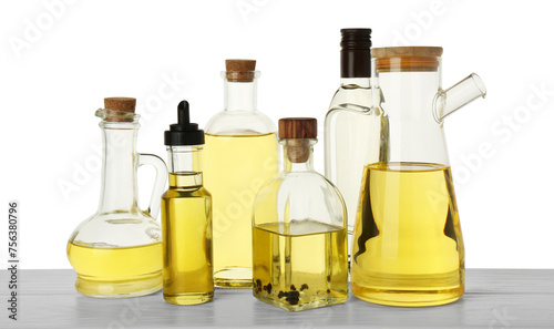 Vegetable fats. Different cooking oils on wooden table against white background