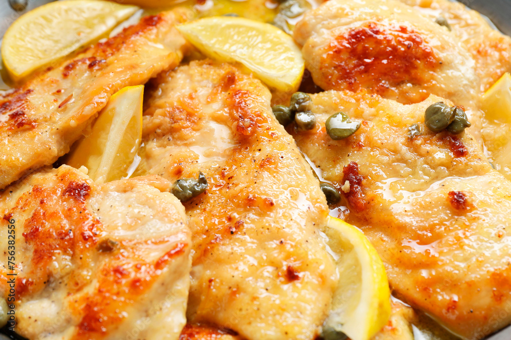 Delicious chicken piccata with lemons as background, closeup Delicious chicken piccata with lemons as background, closeup