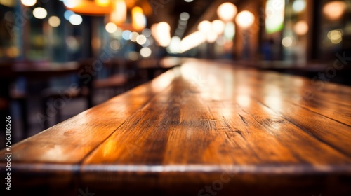 Close-up of an empty wooden table in a restaurant with blurred background