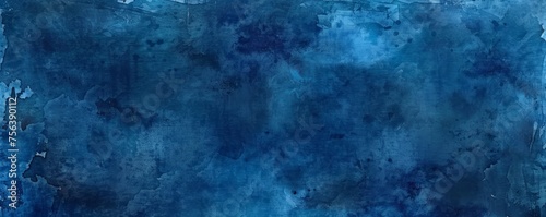A backdrop of dark blue watercolor paint, providing a textured grunge effect that can serve as a dramatic background or banner. photo