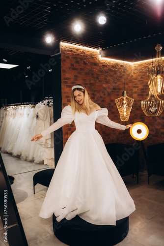 Beautiful bride wearing a wedding dress in a wedding salon