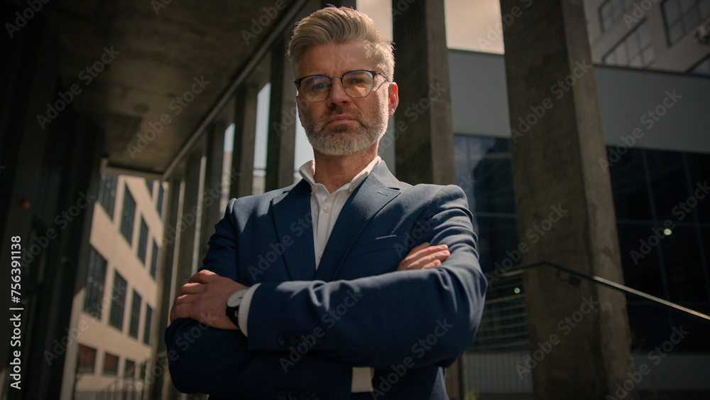 Business portrait outdoors in city senior worker leader company owner middle-aged Caucasian man businessman looking camera posing near office building outside hands crossed male employer entrepreneur