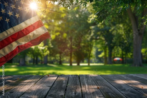 A serene park at sunrise with the American flag proudly on display, the sun's rays filtering through the trees in the background..