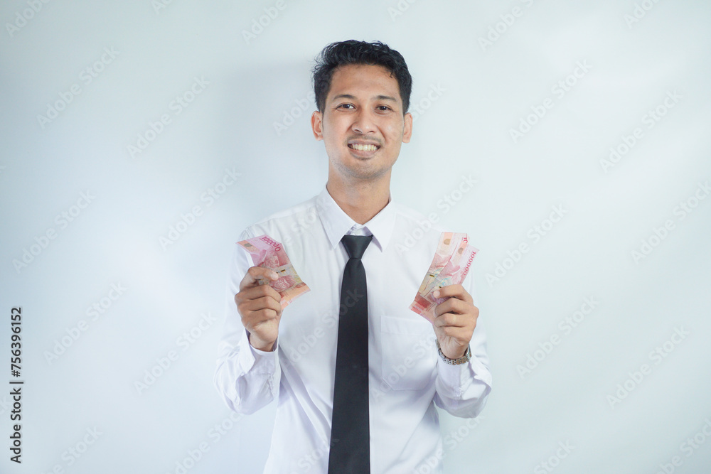 Adult Asian man showing happy face expression while holding paper money Adult Asian man showing happy face expression while holding paper money
