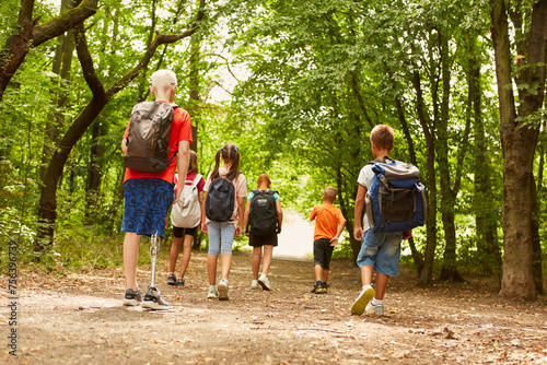 Kids exploring forest while waking on path