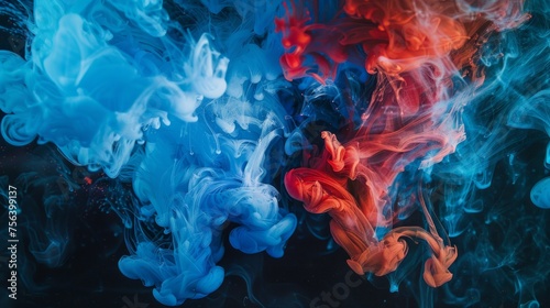 Abstract artistic expression of blue and red acrylic colors mixing in water, creating an ink blot pattern on a dark background. photo