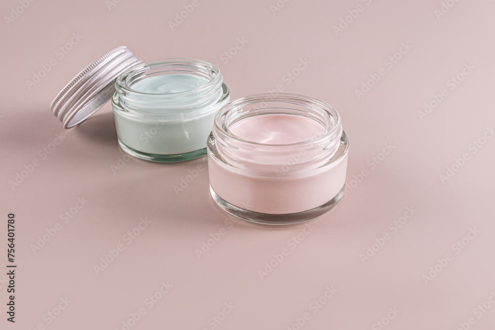 Two open cosmetic jars with a natural cosmetic product for self-care. Organic cosmetics. Coloured cream.