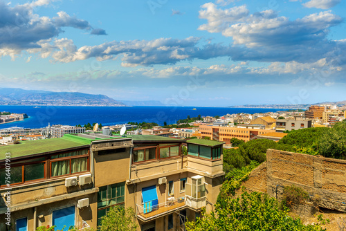 panoramic summer travel view from a hill to  beautiful sea coast historical town with port, amazing ocean bay and gulf and beautiful mountains with scenic sunset on background.