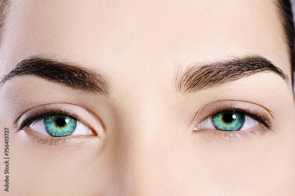 Fototapeta premium Beautiful woman with captivating turquoise eyes, closeup