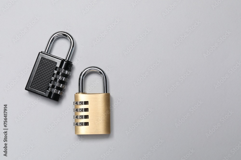 Steel combination padlocks on grey background, top view. Space for text Steel combination padlocks on grey background, top view. Space for text