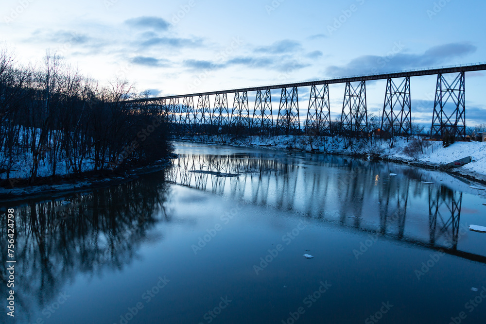 Blue hour view of the 1908 railway trestle bridge over the Cap-Rouge River seen during a winter sunrise, Cap-Rouge area, Quebec City, Quebec, Canada