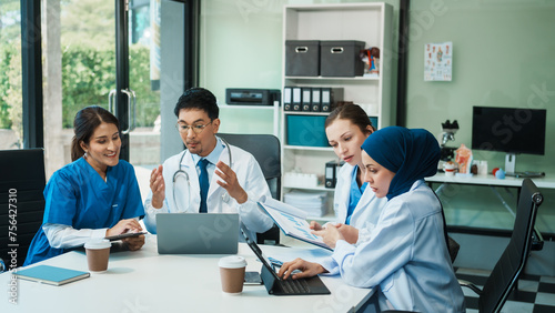 A diverse group of healthcare professionals, including doctors, nurses, and specialists, engaging in a collaborative meeting to discuss medical cases and share expertise in a hospital