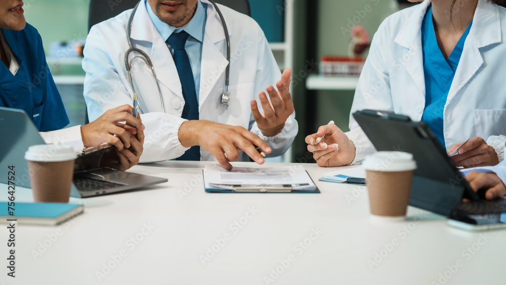 A diverse group of healthcare professionals, including doctors, nurses, and specialists, engaging in a collaborative meeting to discuss medical cases and share expertise in a hospital A diverse group of healthcare professionals, including doctors, nurses, and specialists, engaging in a collaborative meeting to discuss medical cases and share expertise in a hospital