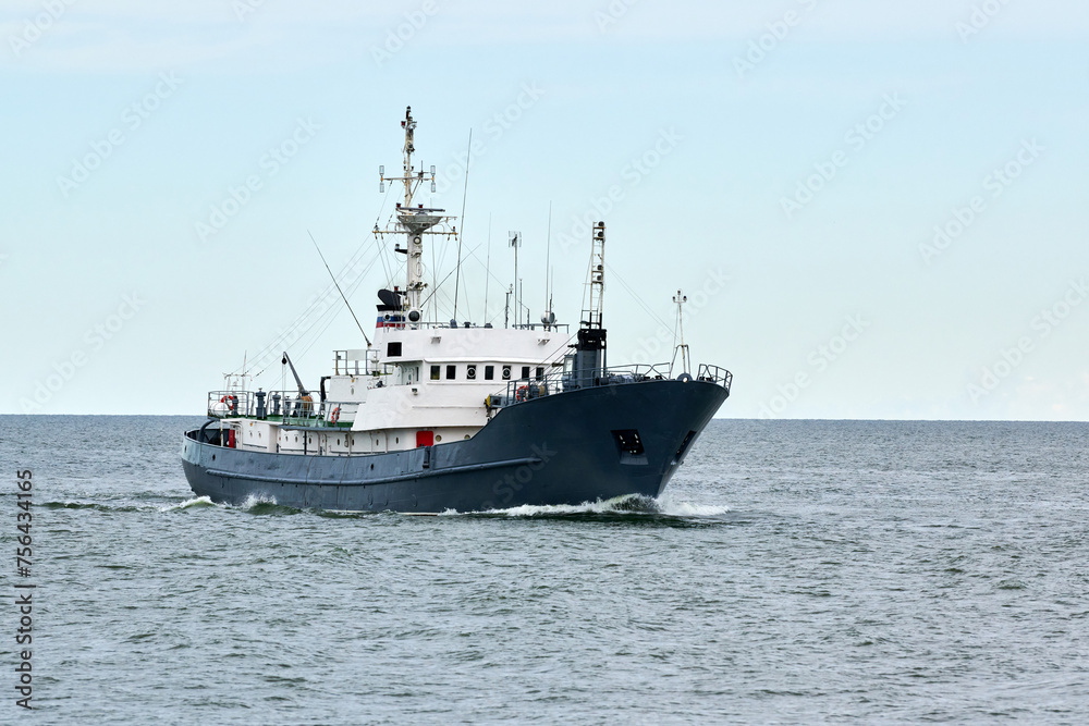 Russian warship armed with armament sails into sea toward military target to attack and destroy enemy, military ship performing strategic maneuver, Russian sea power deployment for tactical advantage