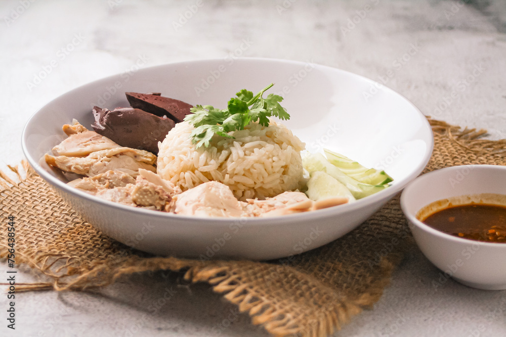 Hainanese chicken rice with soup on dark wooden table background. thaifood concept. Hainanese chicken rice with soup on dark wooden table background. thaifood concept.