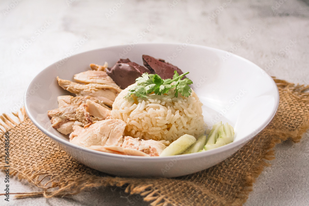 Hainanese chicken rice with soup on dark wooden table background. thaifood concept.
